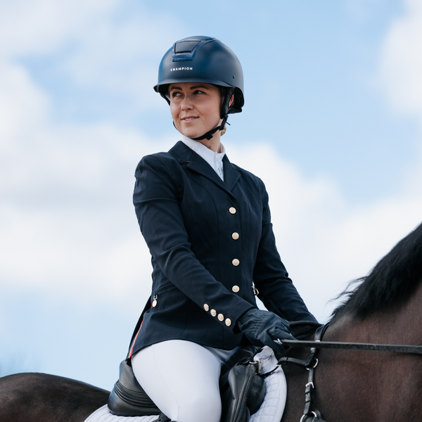 Person in equestrian attire sitting on a horse with a blue sky background. Insight Standard Peaked Helmet Navy Matt