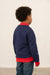 Child wearing a navy and red jacket 